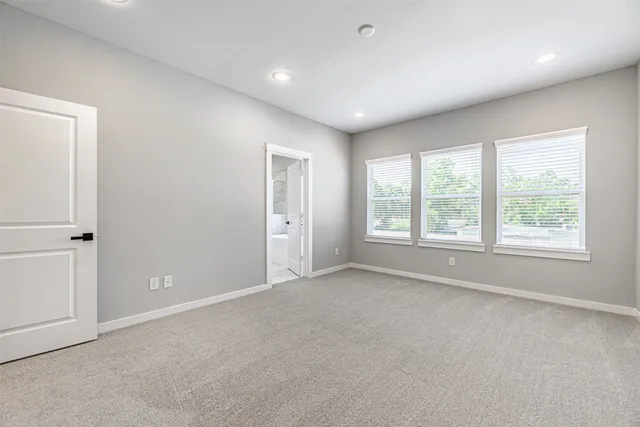 an empty room with windows and closet