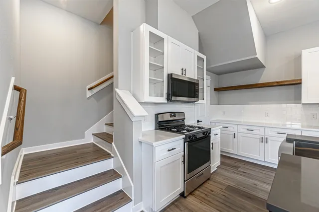 a kitchen with a sink stove and microwave