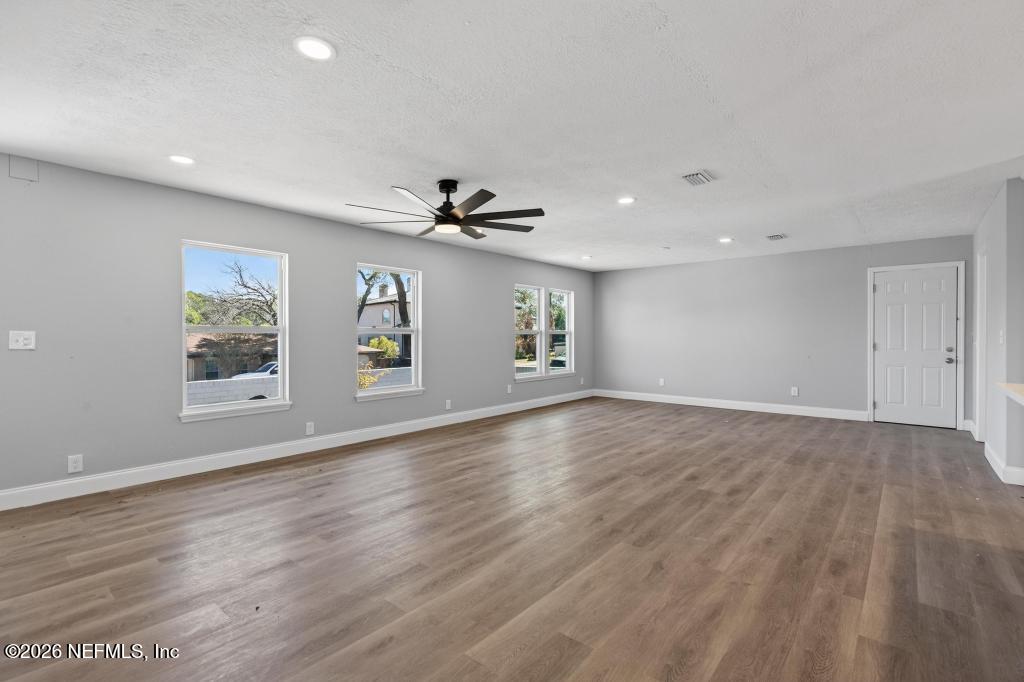 4040 Cove St Johns Road Jacksonville, FL 32277 - Photo 16 of 101 a view of an empty room with window and wooden floor