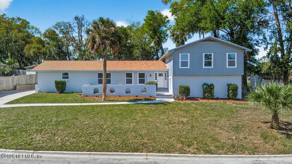 4040 Cove St Johns Road Jacksonville, FL 32277 - Photo 2 of 101 a front view of a house with a yard and garage