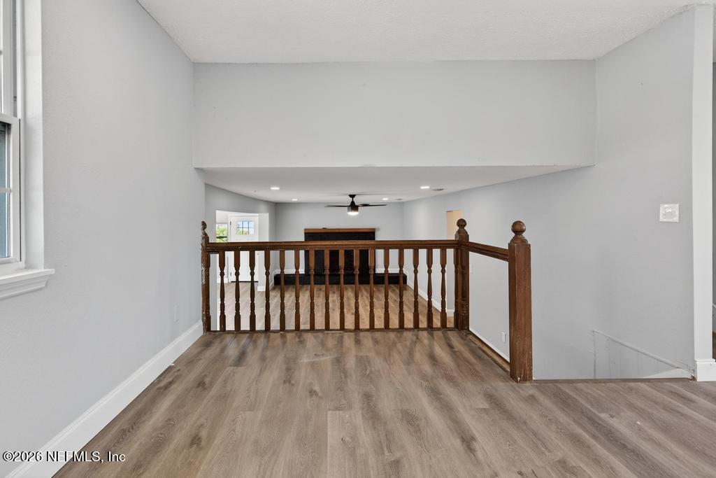 4040 Cove St Johns Road Jacksonville, FL 32277 - Photo 23 of 101 a view of a hallway with wooden floor and stairs