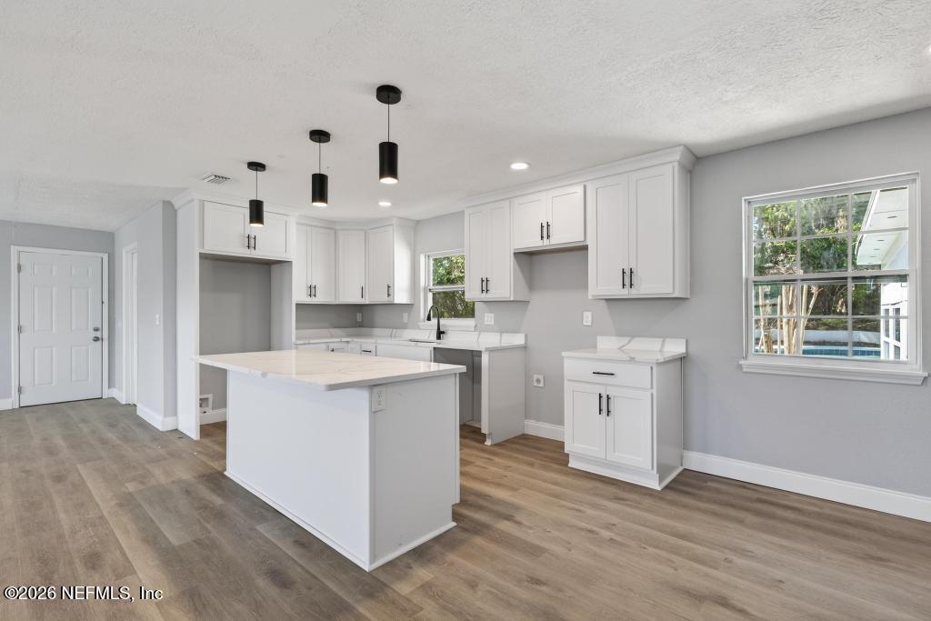 4040 Cove St Johns Road Jacksonville, FL 32277 - Photo 26 of 101 a kitchen with white cabinets white stainless steel appliances and sink