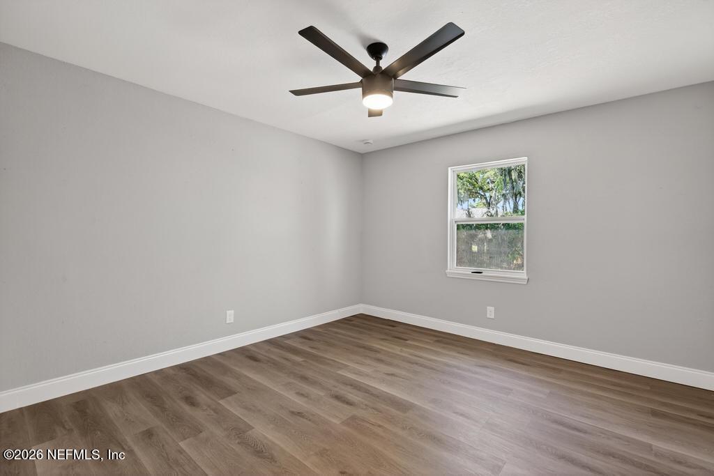 4040 Cove St Johns Road Jacksonville, FL 32277 - Photo 34 of 101 an empty room with wooden floor and windows