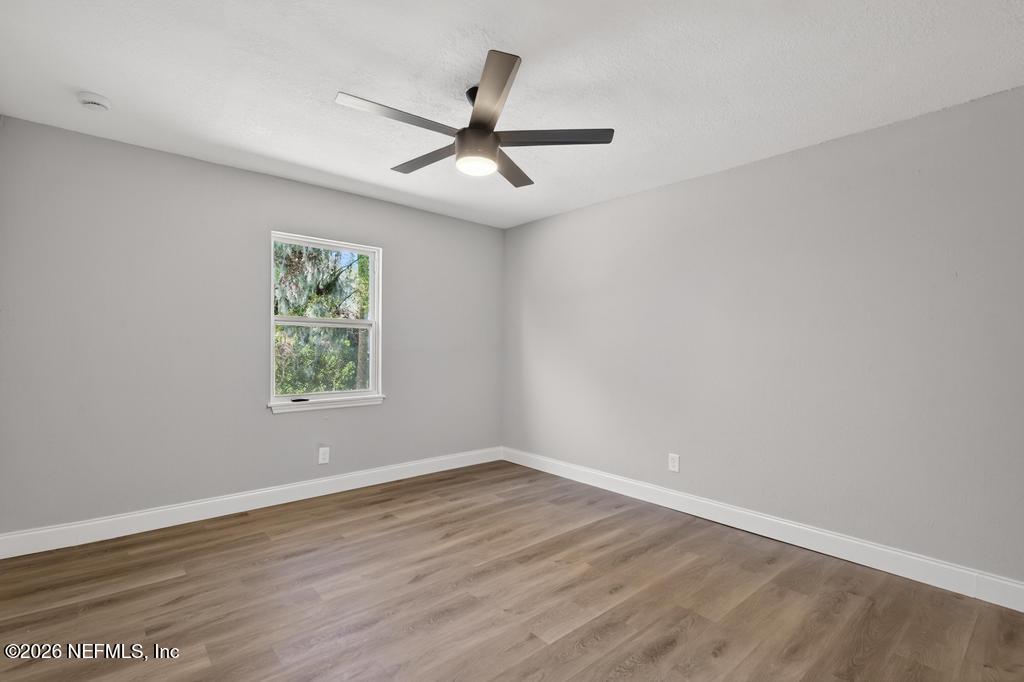 4040 Cove St Johns Road Jacksonville, FL 32277 - Photo 36 of 101 an empty room with wooden floor and windows