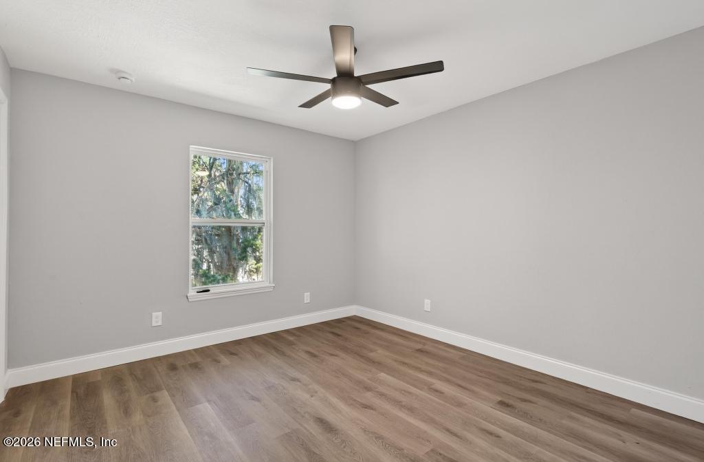 4040 Cove St Johns Road Jacksonville, FL 32277 - Photo 38 of 101 an empty room with wooden floor and windows