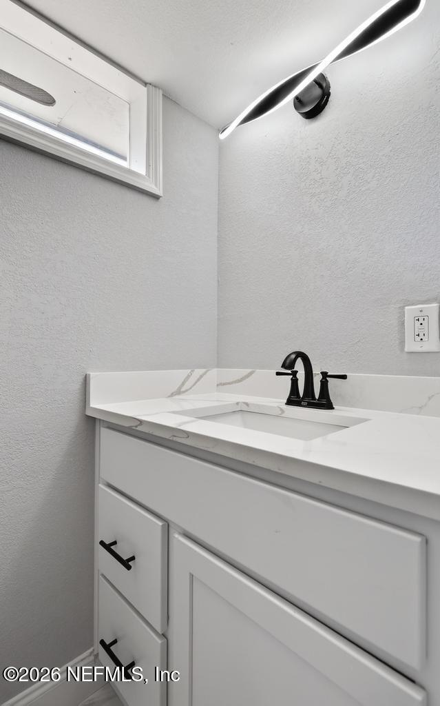 4040 Cove St Johns Road Jacksonville, FL 32277 - Photo 49 of 101 a bathroom with a sink and vanity