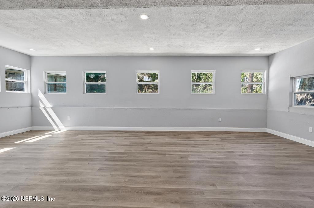 4040 Cove St Johns Road Jacksonville, FL 32277 - Photo 55 of 101 a view of an empty room with window and wooden floor