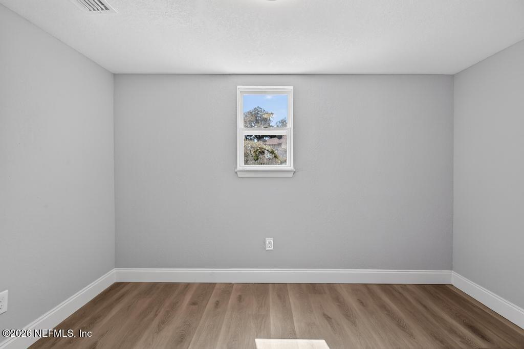 4040 Cove St Johns Road Jacksonville, FL 32277 - Photo 65 of 101 a view of a big room with wooden floor and window
