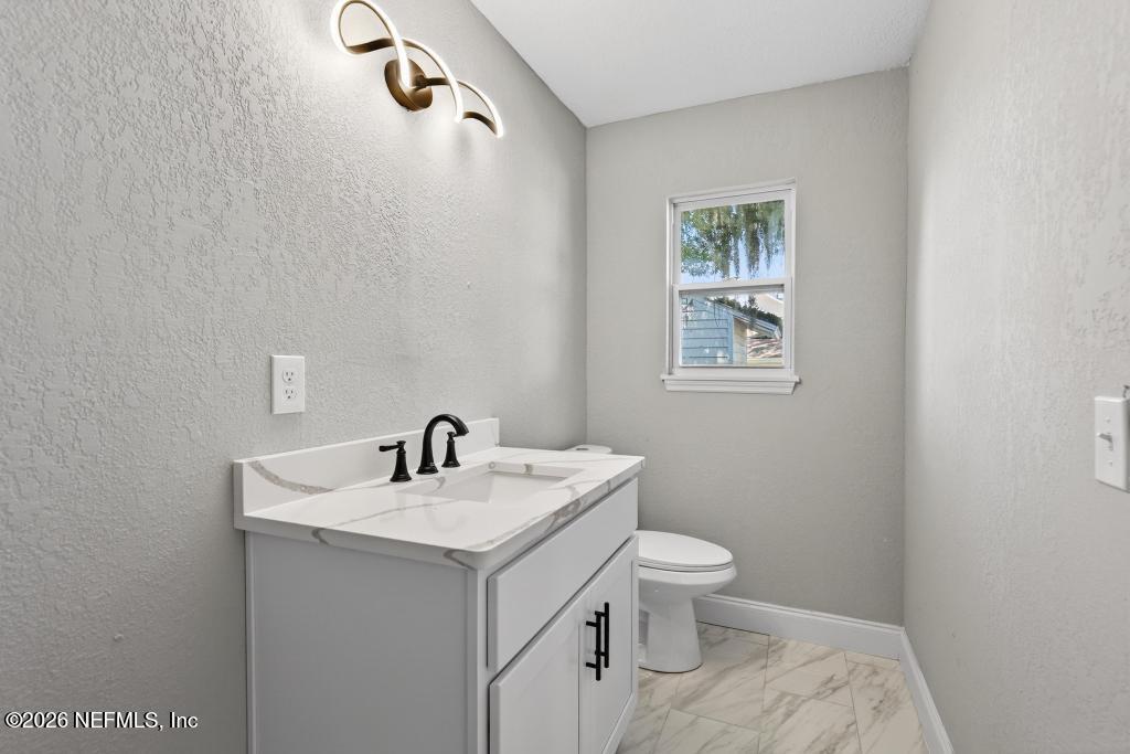 4040 Cove St Johns Road Jacksonville, FL 32277 - Photo 70 of 101 a bathroom with a sink toilet and a mirror