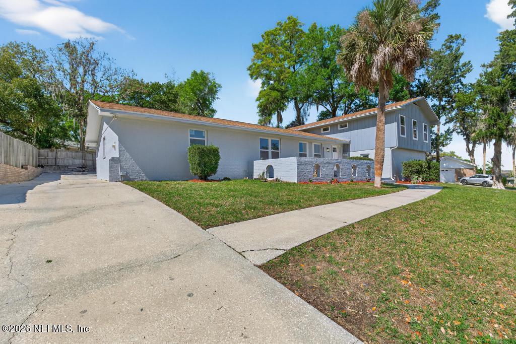 4040 Cove St Johns Road Jacksonville, FL 32277 - Photo 7 of 101 a view of a house with a yard and large tree