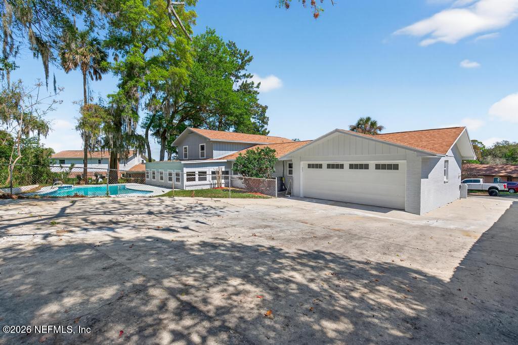 4040 Cove St Johns Road Jacksonville, FL 32277 - Photo 73 of 101 a front view of a house with a yard and garage