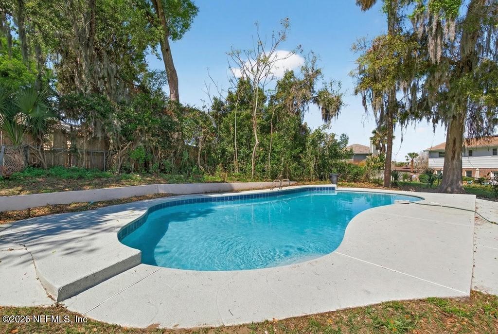 4040 Cove St Johns Road Jacksonville, FL 32277 - Photo 75 of 101 a view of a swimming pool with a yard