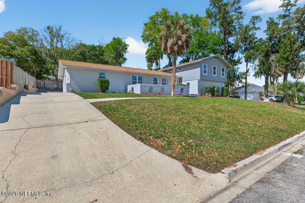 4040 Cove St Johns Road Jacksonville, FL 32277 - Photo 8 of 101 a front view of a house with garden