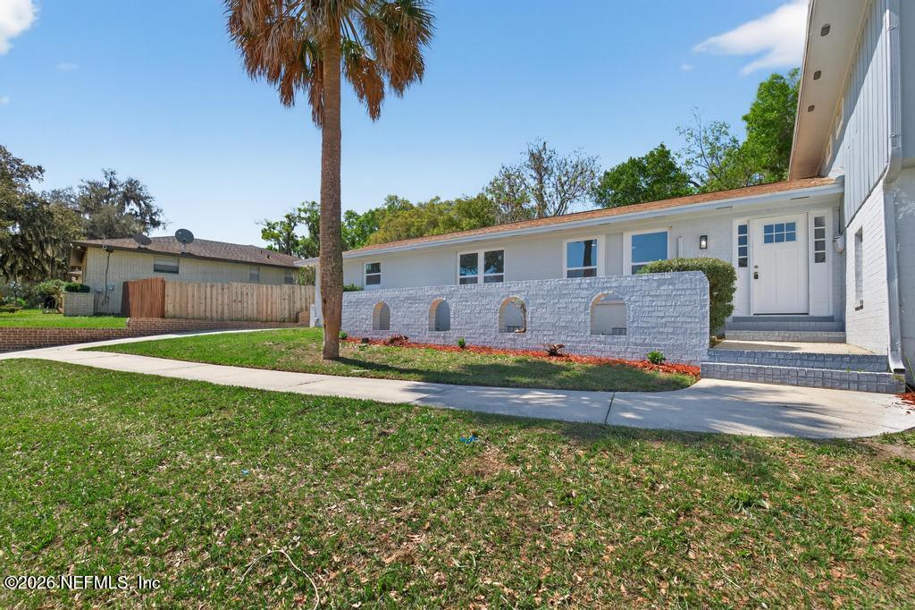 4040 Cove St Johns Road Jacksonville, FL 32277 - Photo 10 of 101 a front view of house with yard and seating space