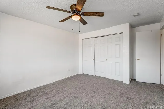 a view of a room with a ceiling fan