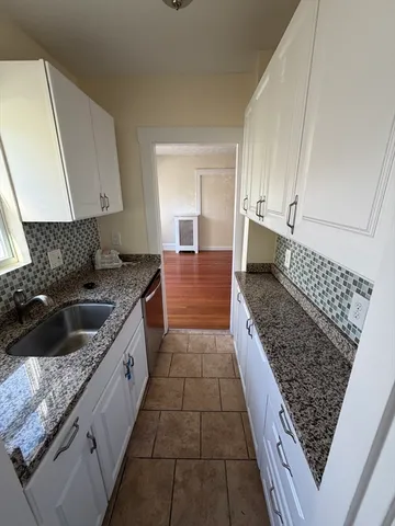 a kitchen with sink and cabinets