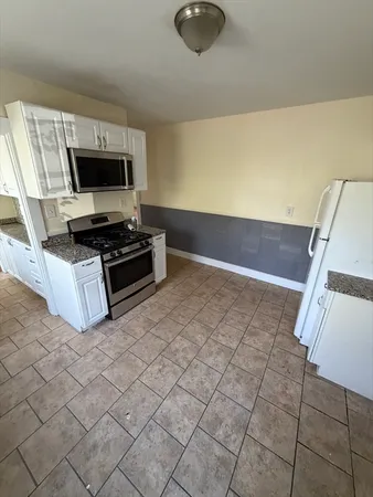 a kitchen with stainless steel appliances a stove a sink and a refrigerator
