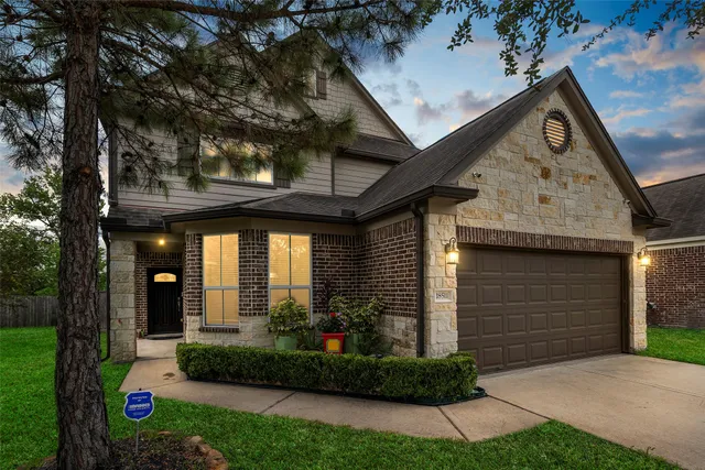 a front view of a house with a plants