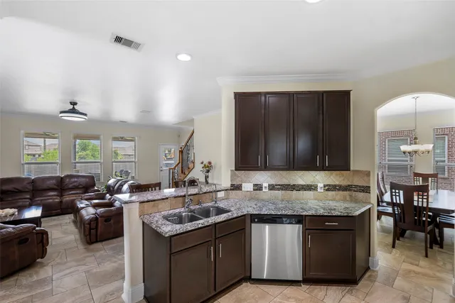 a dining room with furniture a chandelier and window