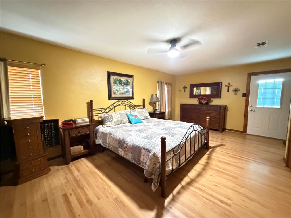 330 South Goode Road Wilmer, TX 75172 - Photo 23 of 38 a bedroom with a bed and wooden floor
