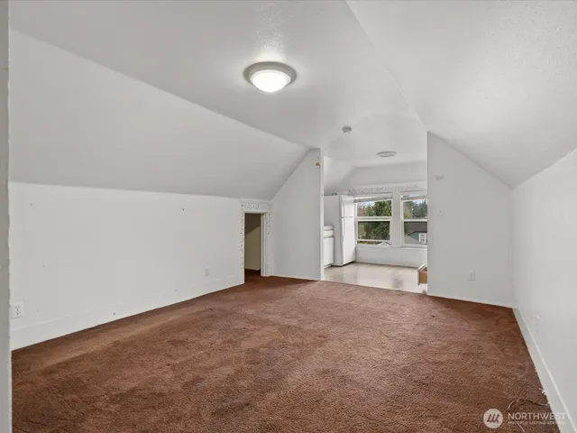 a bathroom with a granite countertop toilet sink and mirror