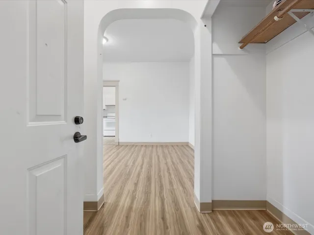 a view of a hallway with wooden floor