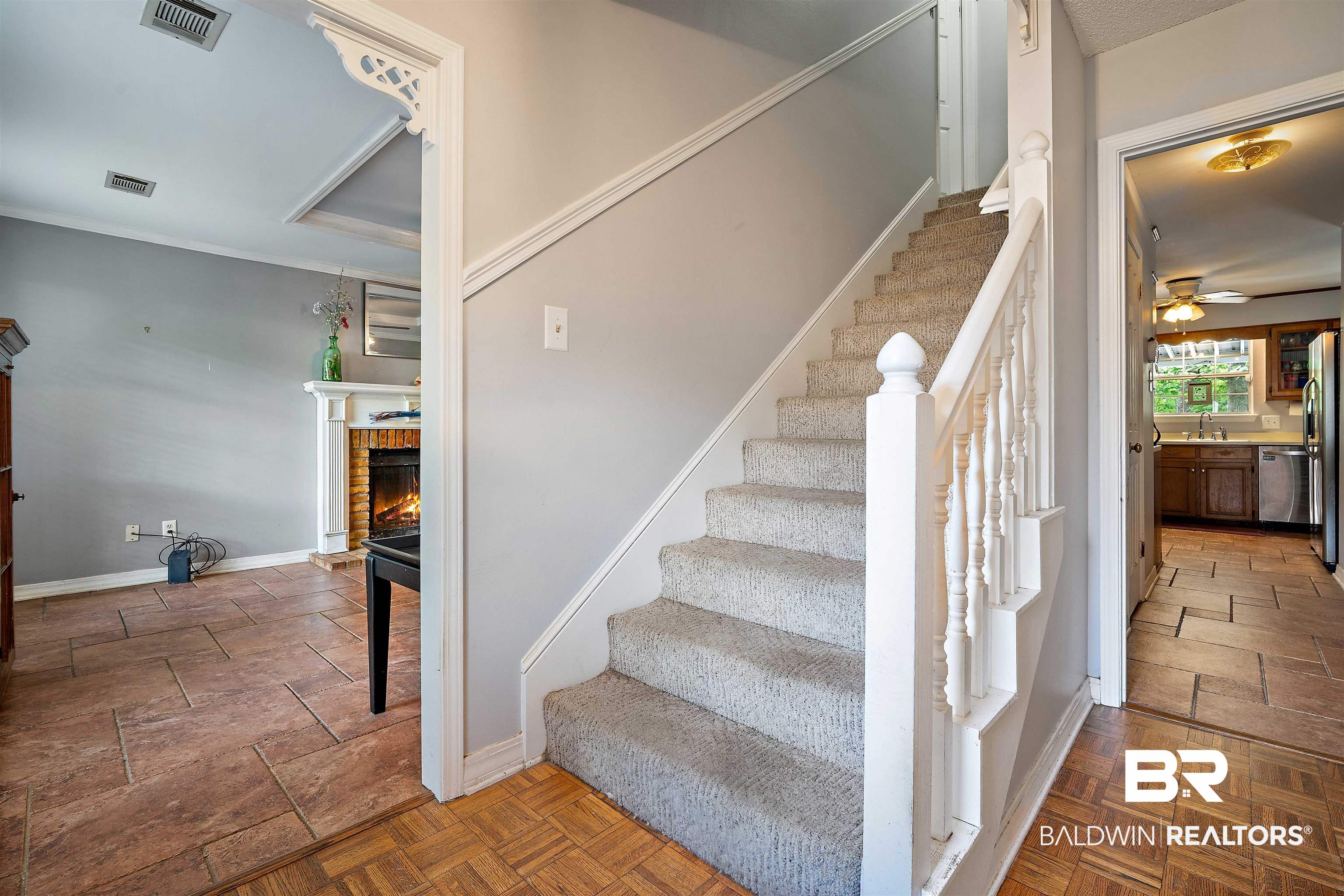 2823 Woodland Road Mobile, AL 36693 - Photo 14 of 29 Staircase with baseboards, a ceiling fan, a brick fireplace, and visible vents