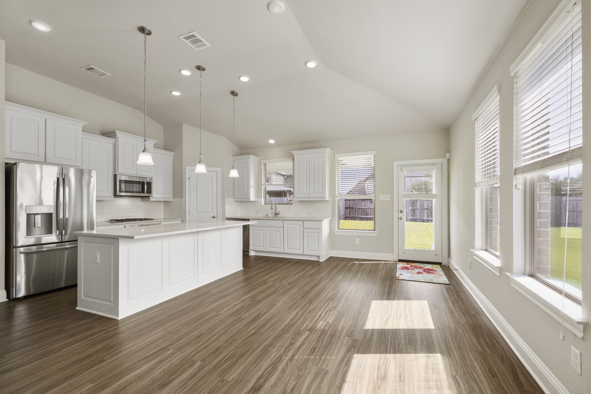 7502 Windsor Park Court Spring, TX 77379 - Photo 11 of 50 a large kitchen with stainless steel appliances kitchen island a large counter top and a wooden floors