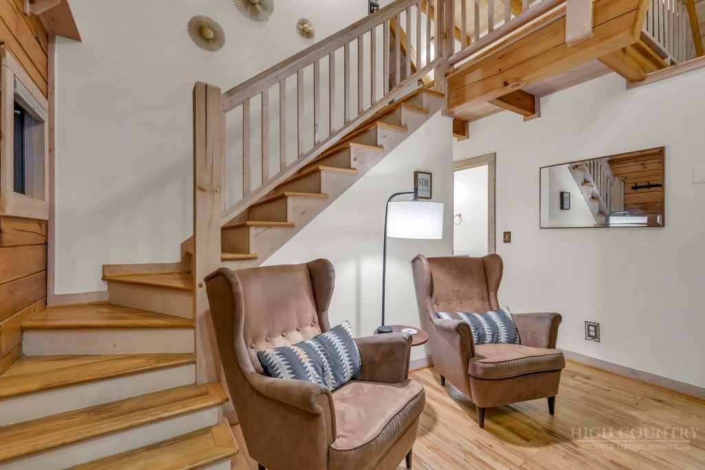 192 Dewitt Barnett Road Vilas, NC 28692 - Photo 6 of 32 a living room with furniture and stairs
