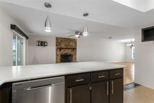 an empty room with a chandelier fan