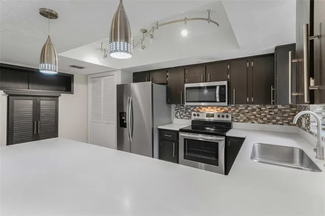 an empty room with fan and entrance