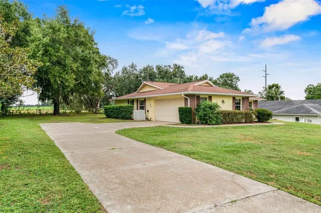 a front view of house with yard and green space