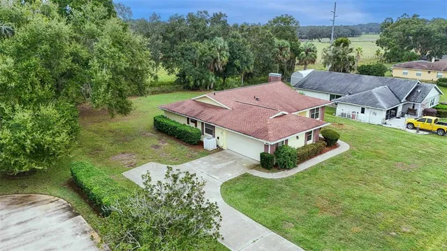 an aerial view of a house with garden space and lake view