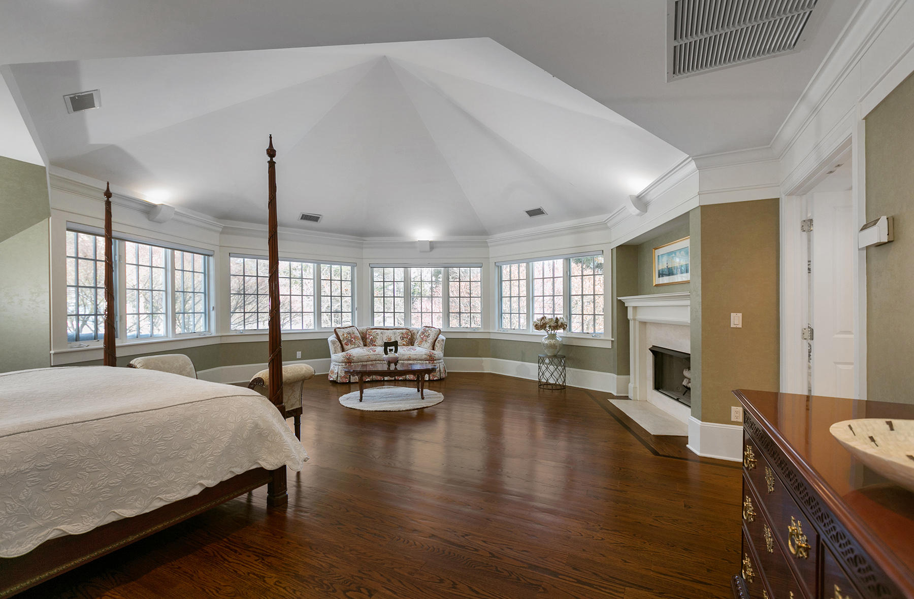 48 Old Farm Road Darien, CT 06820 - Photo 20 of 36 a spacious bedroom with a bed a table chairs and flat screen tv