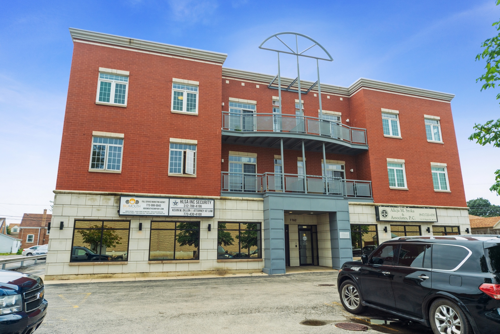 7742 West Higgins Road, Unit 301 Chicago, IL 60631 - Photo 1 of 14 a front view of a building with parking space and parking space