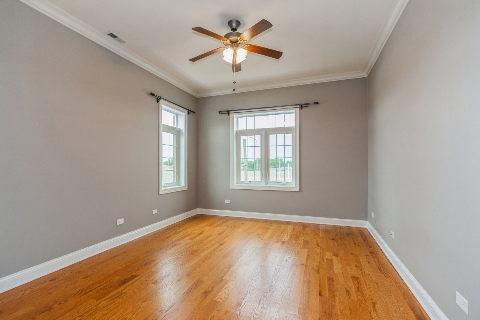 7742 West Higgins Road, Unit 301 Chicago, IL 60631 - Photo 12 of 14 wooden floor in an empty room with a window