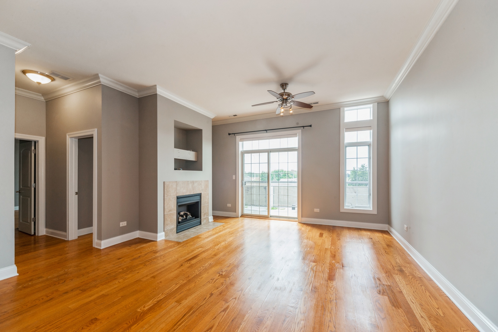 7742 West Higgins Road, Unit 301 Chicago, IL 60631 - Photo 3 of 14 a view of an empty room with window and wooden floor