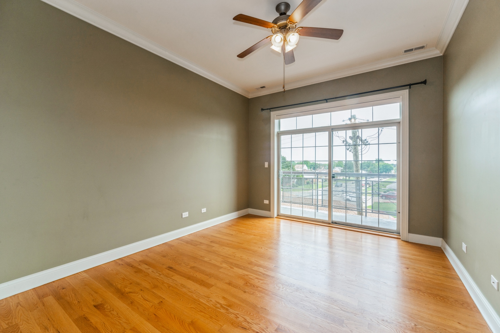 7742 West Higgins Road, Unit 301 Chicago, IL 60631 - Photo 8 of 14 wooden floor in an empty room with a window