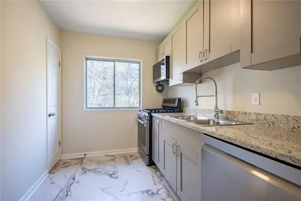 a kitchen with a sink cabinets and window