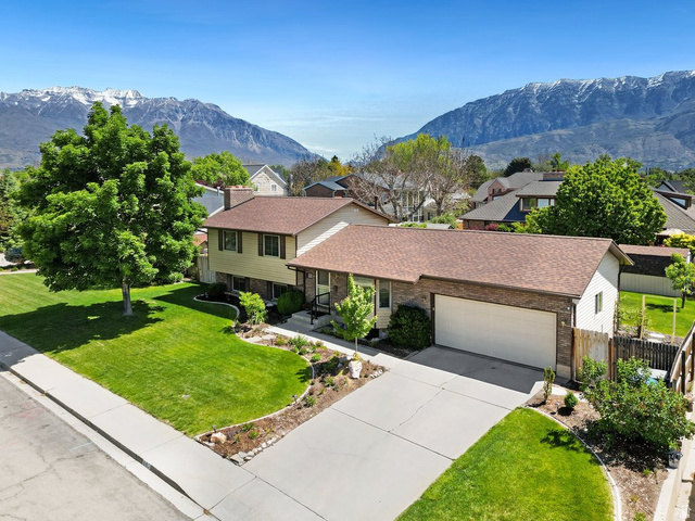 865 South 325 West Orem, UT 84058 - Photo 1 of 38 Split-level residence featuring a two-car garage, brick and siding exterior, and a brown shingle roof