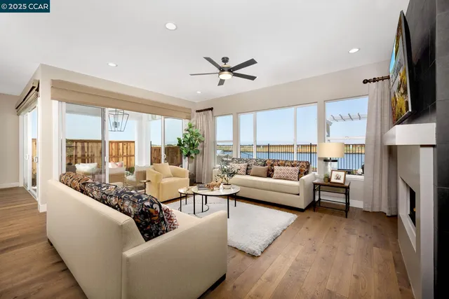 a living room with furniture fireplace and a large window