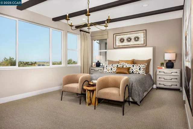 a bedroom with a bed and a chair