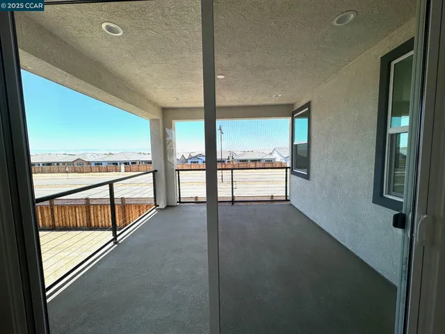 a view of an empty room with large windows