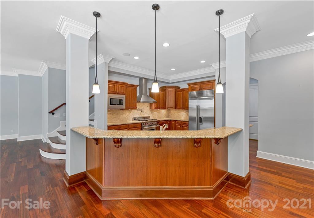 2 Ashbrook Meadows Fletcher, NC 28732 - Photo 13 of 48 a kitchen with kitchen island a counter top space a sink a wooden floor and a window
