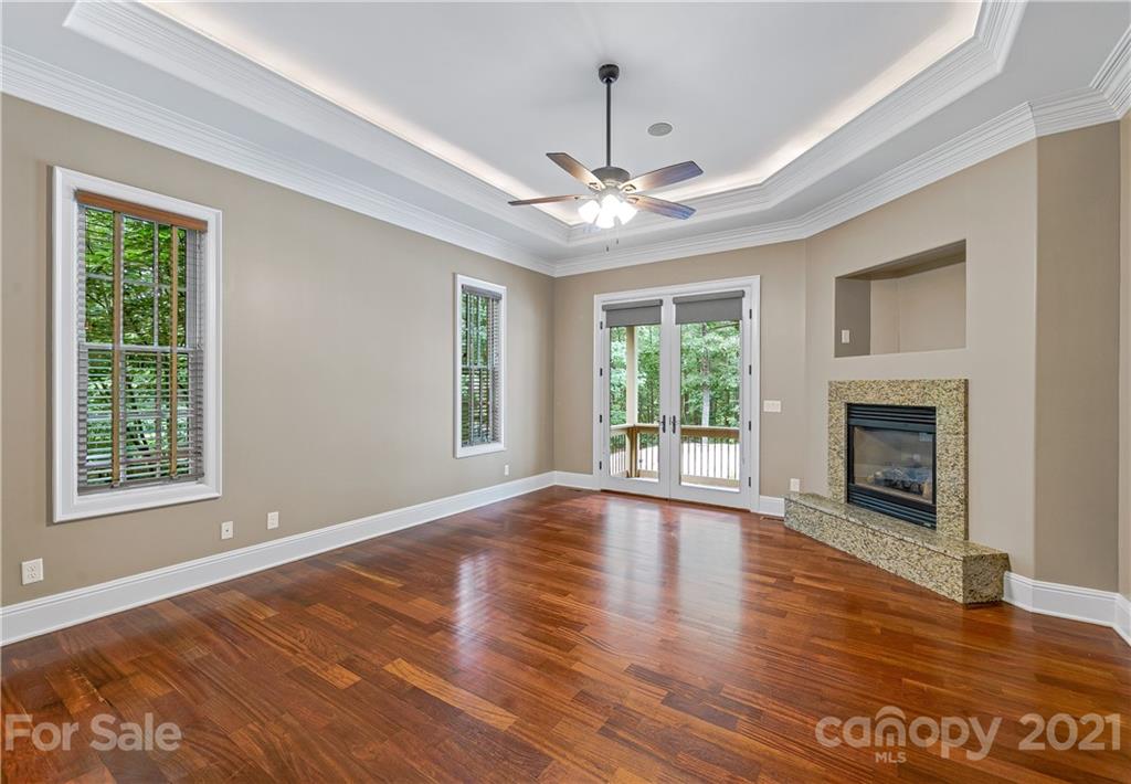 2 Ashbrook Meadows Fletcher, NC 28732 - Photo 18 of 48 a view of an empty room with wooden floor fireplace and a window