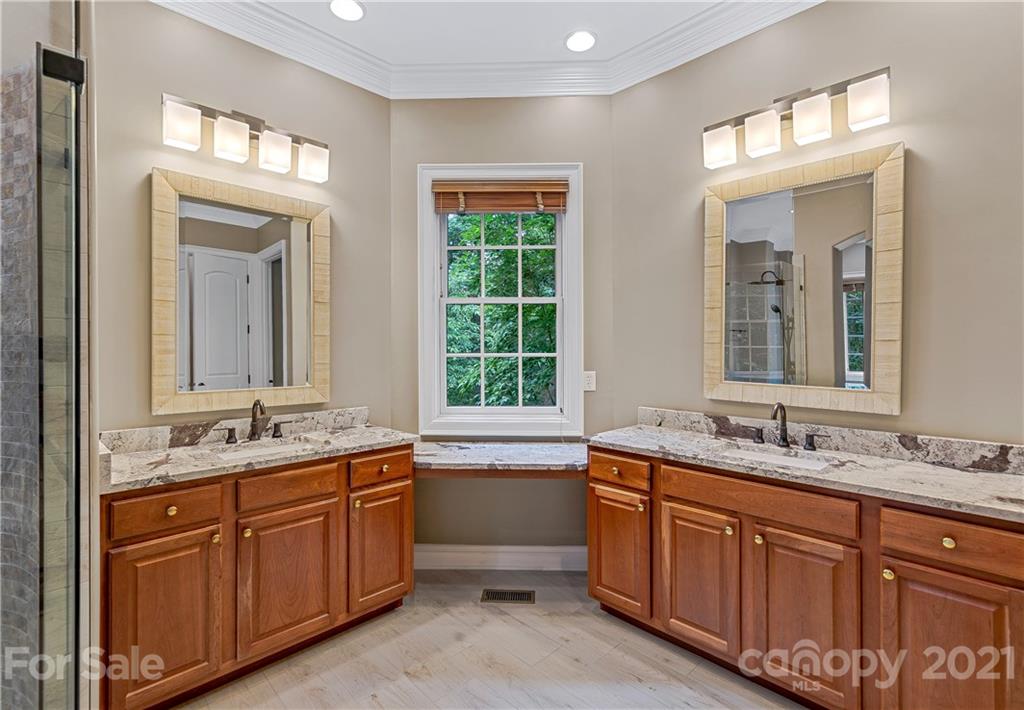 2 Ashbrook Meadows Fletcher, NC 28732 - Photo 19 of 48 a bathroom with a granite countertop double vanity sink a mirror and a bathtub
