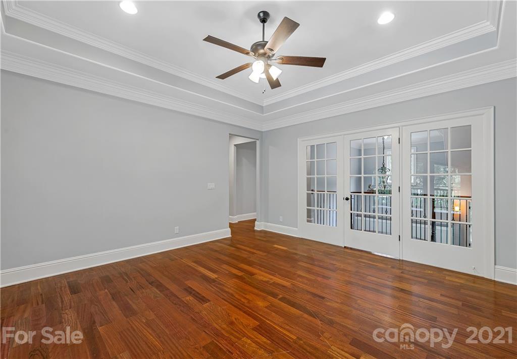 2 Ashbrook Meadows Fletcher, NC 28732 - Photo 27 of 48 a view of an empty room with wooden floor and a ceiling fan