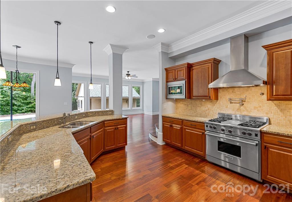 2 Ashbrook Meadows Fletcher, NC 28732 - Photo 4 of 48 a kitchen with stainless steel appliances granite countertop a stove a sink and a wooden floors