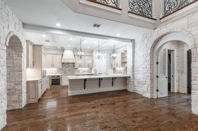 a large kitchen with stainless steel appliances kitchen island a large island in the center