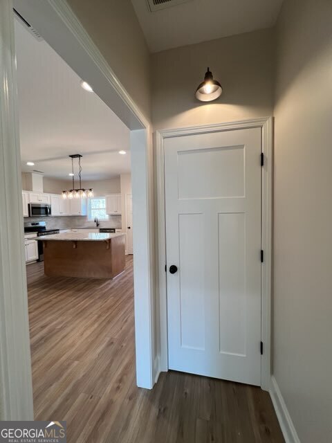 1251 South L Street Hamilton, GA 31811 - Photo 12 of 39 a view of kitchen and empty room with wooden floor